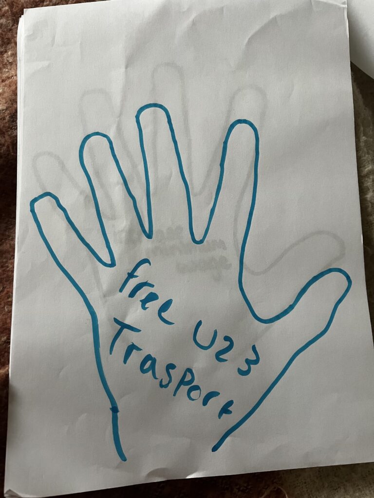 Handprint drawn by a young person, message inside hadnprint reads 'Free Under 23 transport'